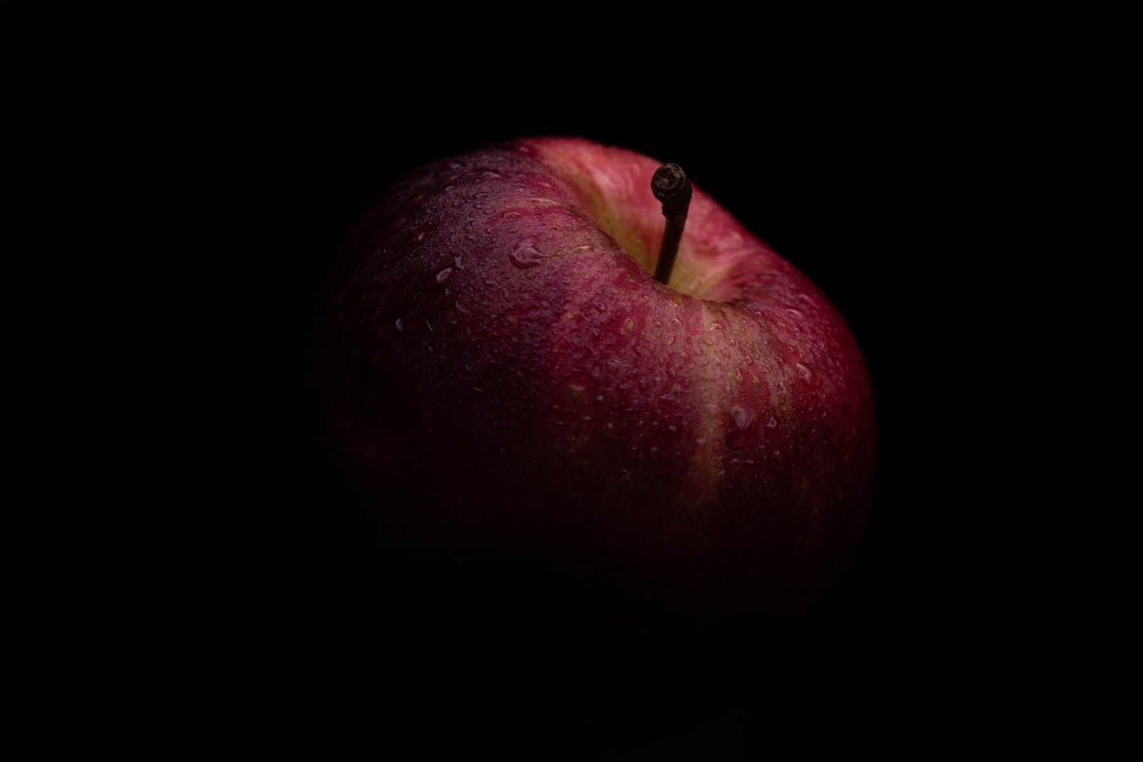 red apple with black background